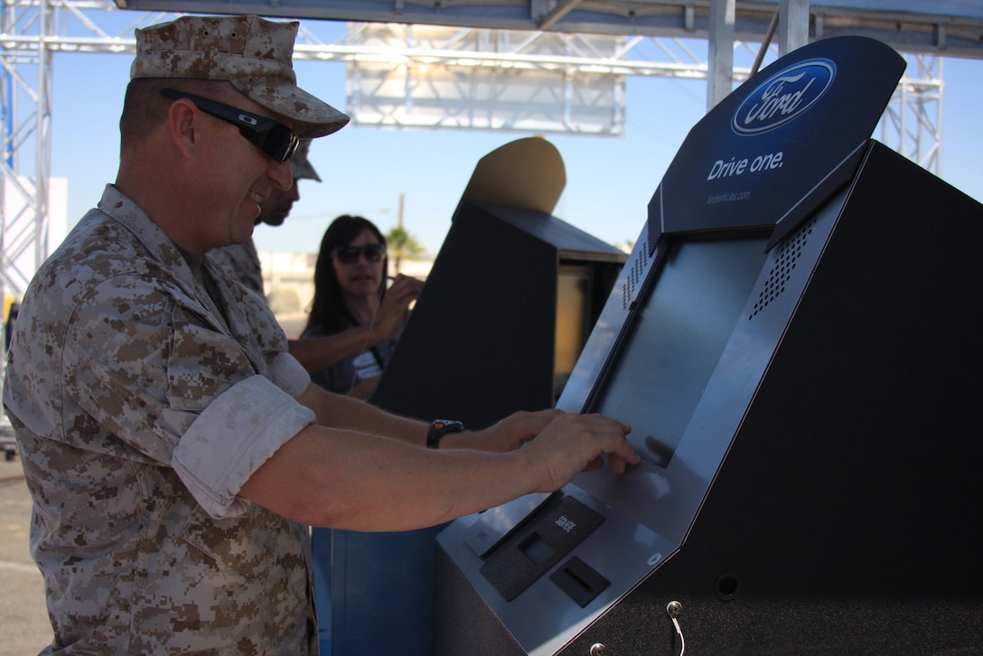 Staff Sgt. Kevin Brophy, the training staff noncommissioned officer in charge for Marine Wing Support Squadron 374, registers for the Ford: Operation Drive One event in the Main Exchange's parking lot June 4. Each person who registered at any of the events has a chance to win a private Toby Keith concert for their installation, one of two 2011 Ford Mustangs and one of eight trips to the Ford Championship NASCAR race weekend in November.